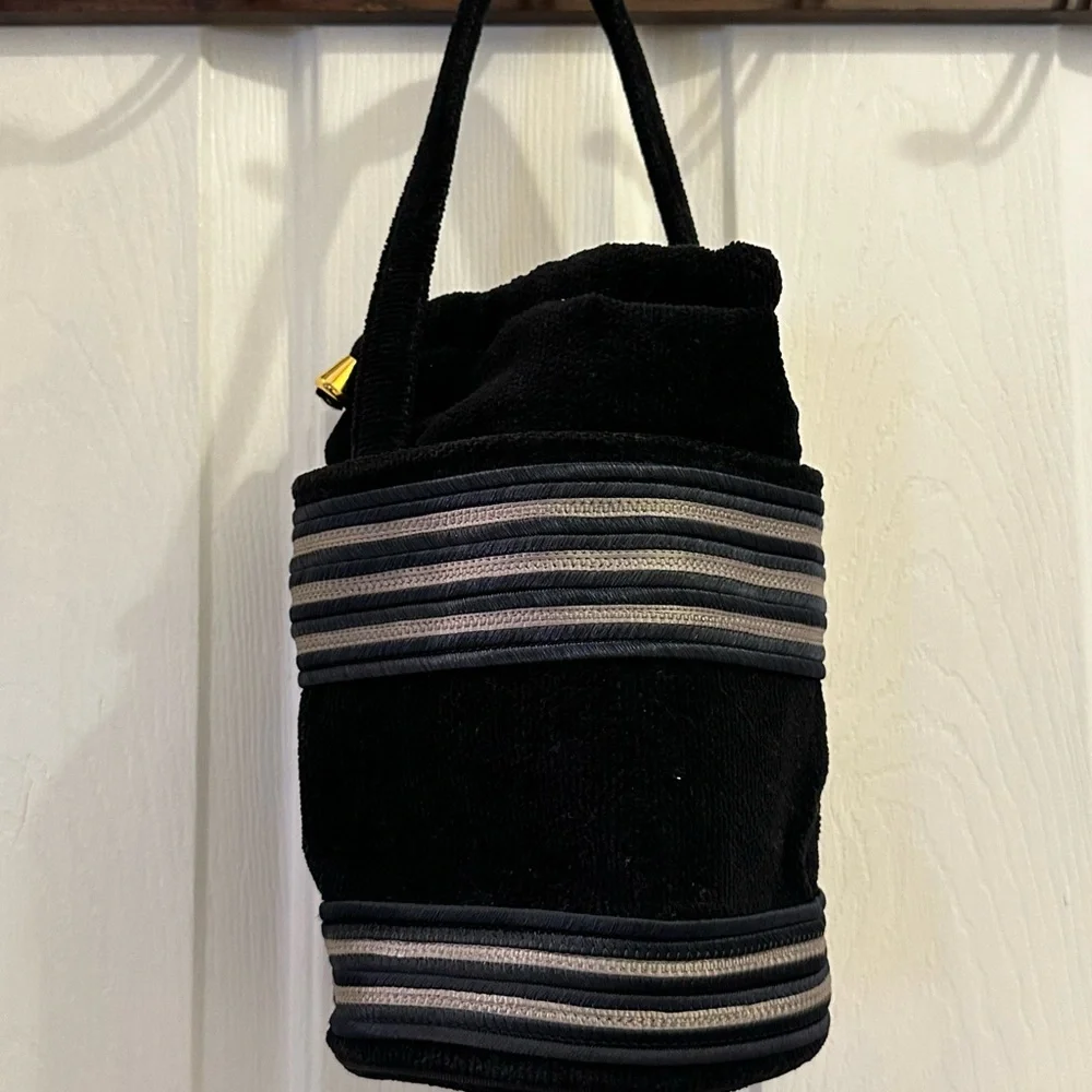 Black Satchel with Striped Accents and Plush Texture